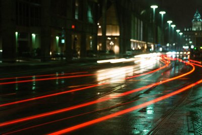 Nächtliche Lichtspuren auf regennasser Straße